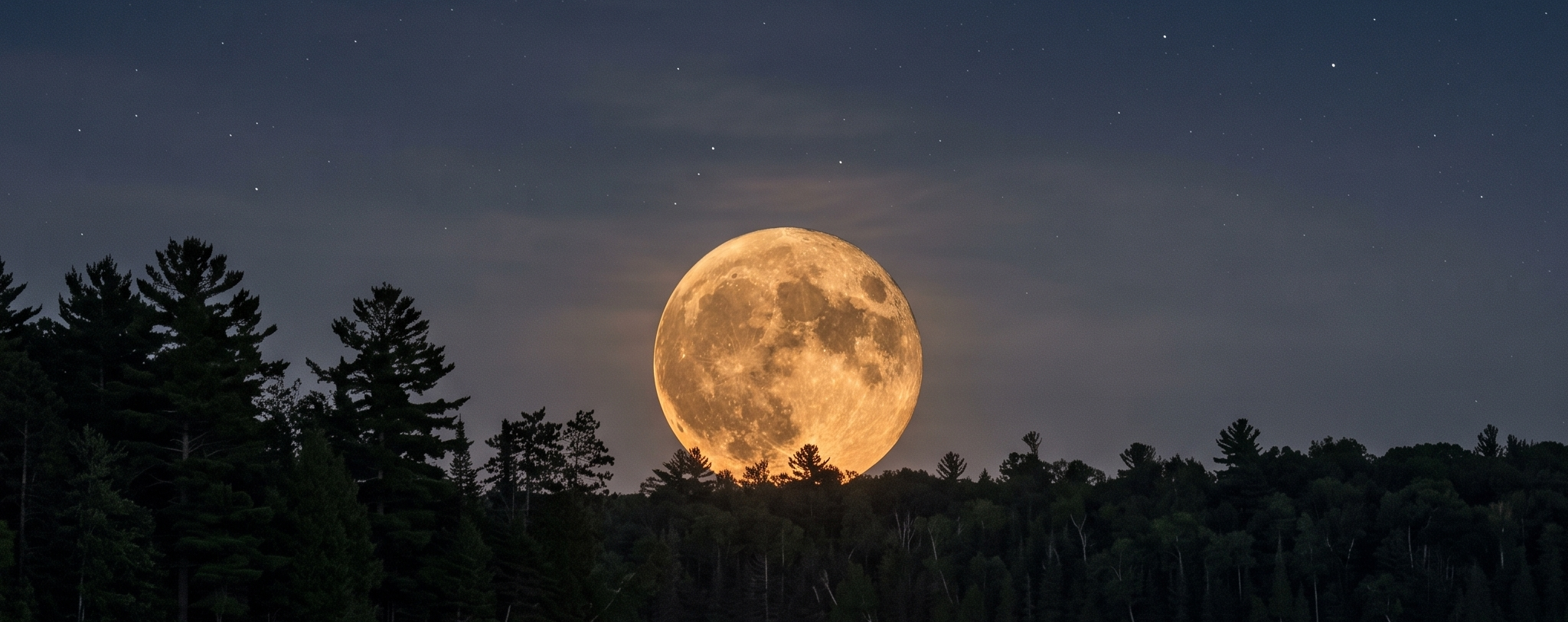 Sturgeon Moon — August's full moon rising over a calm lake at dusk